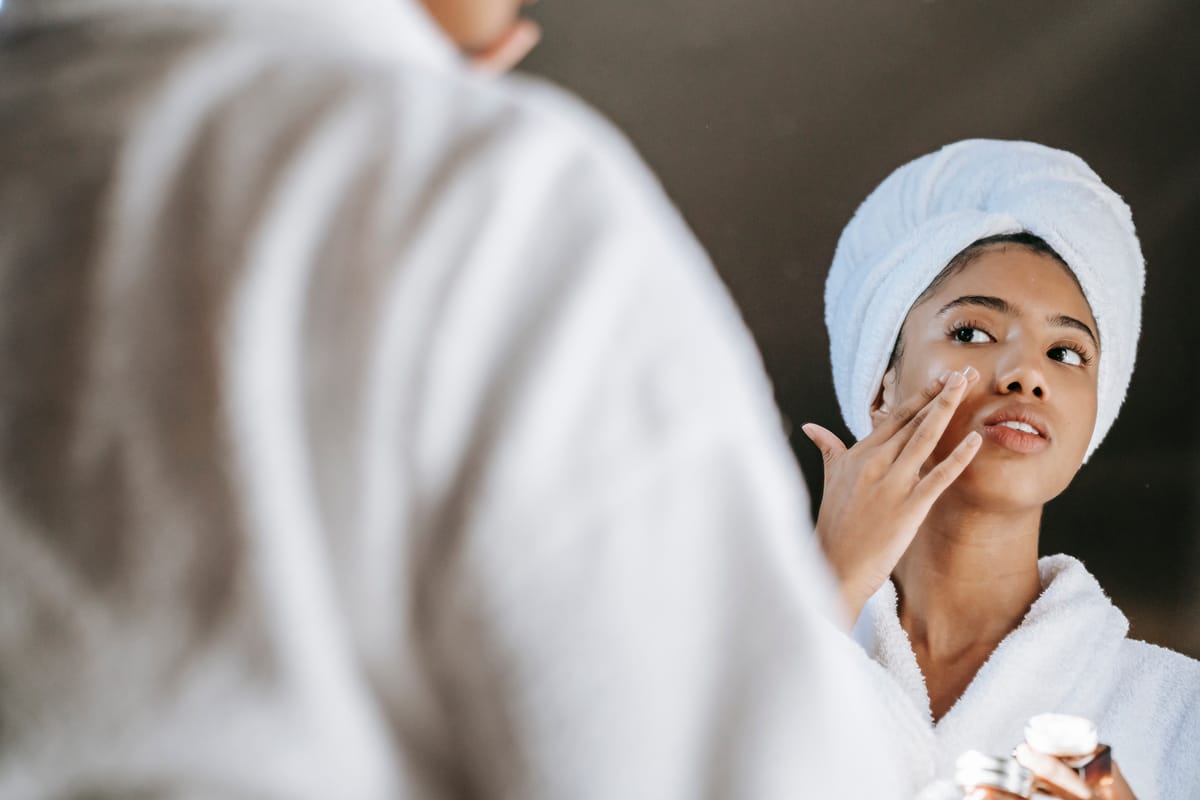 Femme appliquant une crème anti-âge sur son visage